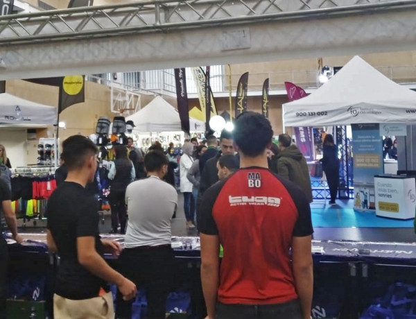 Dos de los jóvenes atienden el puesto para facilitar los dorsales