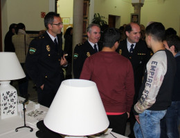 Representantes de la Policía Nacional hablando con menores en la exposición Arte Iuvenis