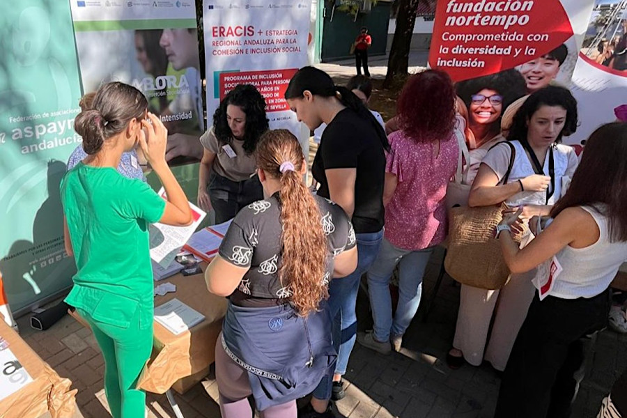 Varias personas se acercan a la mesa informativa de Fundación Diagrama