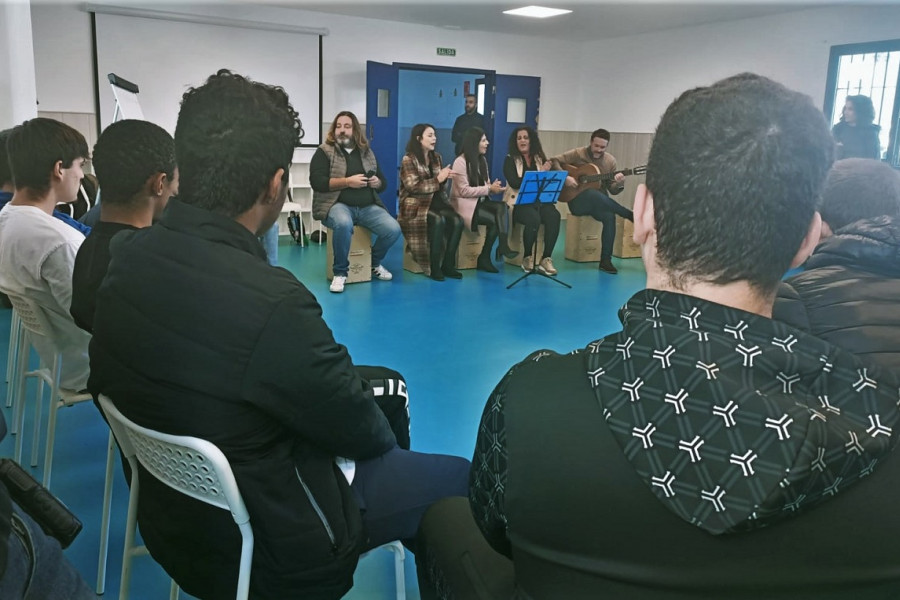 Pepe el Marismeño, junto al grupo de intérpretes que le acompaña, habla con los jóvenes de Odiel